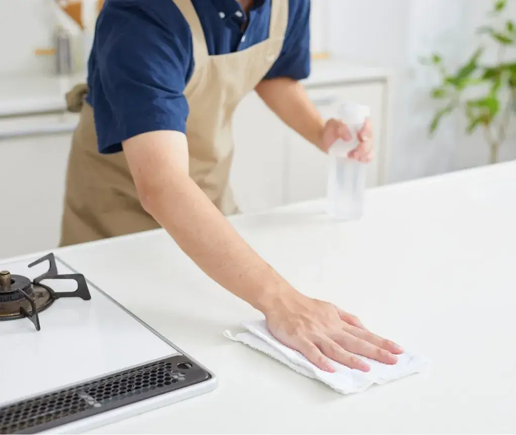 Close-up of a hand wiping down a kitchen surface during a professional house cleaning in Millersville, MD